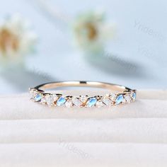 an image of a wedding band with blue and white stones on the inside of it