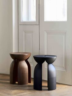 two stools sitting next to each other in front of a door