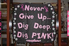 a sign that says never give up dig deep pink