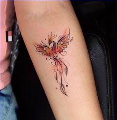 a woman's arm with a bird tattoo on it