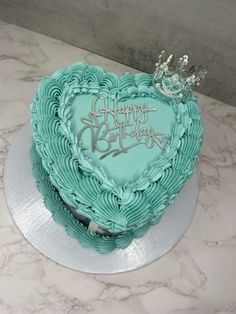 a heart shaped birthday cake with a tiara on top