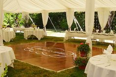 an outdoor wedding reception with tables and chairs