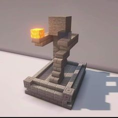 an object that looks like a cross on top of a stone structure with a light coming from it