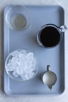 there is ice and coffee on the tray