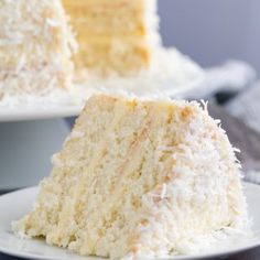 a close up of a slice of cake on a plate with the rest of the cake in the background