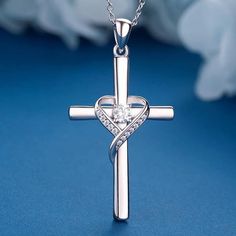 Design: This necklace features a large silver cross pendant with a stunning heart in the center. The combination of the cross and heart symbolizes love, faith, and the presence of hope. The pendant is designed to be a unique and thoughtful gift that conveys the message of courage and best wishes to the person you love. It's a meaningful addition to any woman's cross jewelry collection. Material: The pendant is made of high-quality silver, although the specific type of silver (e.g., sterling silver) is not mentioned in the provided information. The use of silver ensures durability and a timeless look. Measurement: The dimensions of the cross pendant are approximately 1.26 inches in length and 0.8 inches in width, making it a noticeable and elegant piece. The necklace itself has a length of Sterling Silver Cross Pendant Necklace For Anniversary, Mother's Day Sterling Silver Cross Necklace, Silver Cross Pendant Necklace For Mother's Day, Sterling Silver Cross Pendant Jewelry For Valentine's Day, Sterling Silver Cross Necklace For Valentine's Day, Silver Crucifix Cross Necklace For Anniversary, Silver Cross Necklace For Mother's Day, Silver Cross Pendant Necklaces For Valentine's Day, Silver Cross Pendant Necklace For Valentine's Day