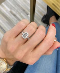 a woman's hand with a diamond ring on it