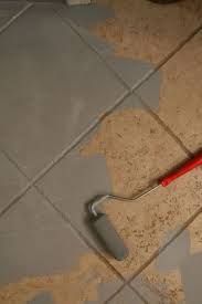 a tile floor with a paint roller laying on it