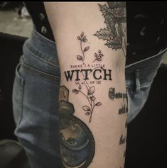 a person with a tattoo on their arm that says, there's a little witch in all of us