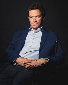 a man sitting in a chair with his arms crossed