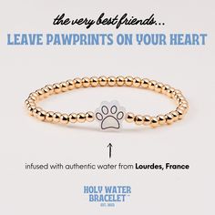 An everyday reminder that the very best friends leave pawprints on your heart. This pawprint is infused with authentic holy water sourced directly from Lourdes, France. 4mm gold plated beads  Flexible stretch cord  Resin pawprint infused with authentic holy water from Lourdes, France 6.8 inch unstretched circumference (similar to a regular-sized bracelet) Gold Paw Print Jewelry For Best Friend Gift, Gold Paw Print Jewelry For Best Friend, Hypoallergenic Gold Charm Bracelet For Friendship, Gold Hypoallergenic Charm Bracelet For Friendship, Everyday Reminder, Lourdes France, Friends Leave, Mantra Bands, Flexible Stretches