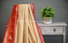 Experience the luxurious feel of our Butter Cream and Dark Red Banarasi Katan Silk Saree. Its intricate patola borders and pallu add a touch of elegance. Made from high-quality silk. Elevate your wardrobe with its timeless piece. The accompanying saree blouse is tailored and embellished with embroidered neckline and also back with handcrafted dori and tassels. The attention to detail further enhances it and gives the blouse a great finish. Elegant Red Tussar Silk Lehenga, Red Raw Silk Saree With Border, Red Silk Traditional Wear With Border, Elegant Red Traditional Wear With Border, Red Blouse Piece With Border For Diwali, Red Blouse Piece With Border For Festive Occasions, Red Semi-stitched Traditional Wear With Border, Red Art Silk Traditional Wear With Border, Red Festive Blouse Piece With Border