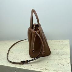 MiNi Shopping Bag CABAS TRIOMPHE Small Smooth Cow Leather Drawstring Bag
9 X 7 X 6 inches (22 X 17 X 15 cm)
Cow leather
Suede cowhide lining
Hand-carry, shoulder and cross-body
Decorative drawstring
POIGNÉES (FLÈCHE : 12.5 CM)
Removable and adjustable shoulder strap, minimum length 18 inches (45 cm), maximum length 21 inches (54 cm)