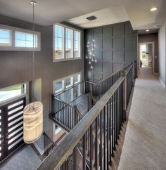 a large open floor plan with stairs and windows