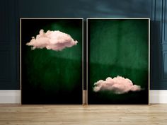 two green and white pictures with clouds in the sky, on wooden floor next to wall