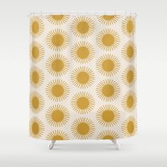 a shower curtain with yellow sunbursts on it