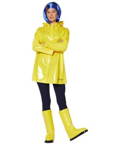 a woman in yellow raincoat standing with her arms crossed