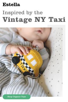 the baby is wearing a yellow taxi hat and holding a toy in it's hand