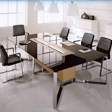 a table with chairs around it in the middle of an empty room that is white and black