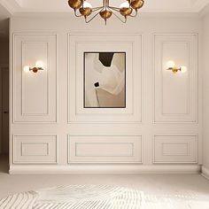 an empty room with white walls and gold fixtures on the wall, along with a chandelier