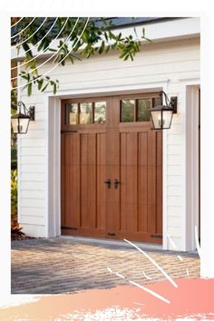 a white house with two brown garage doors and brick walkway leading to the front door