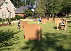 children playing in cardboard boxes on the lawn