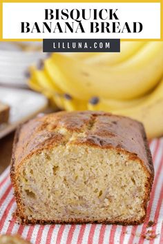 a loaf of banana bread sitting on top of a red and white striped towel next to bananas