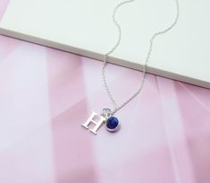 A highly personalised necklace with a genuine blue Sapphire gemstone birthstone charm and a 925 Sterling Silver letter threaded onto delicate 925 Sterling Silver chain. Sapphire is the traditional September Birthstone. Delicate, dainty and pretty, this makes the perfect favourite everyday necklace, and a lovely personalised gift for anyone with a September birthday or who simply loves Sapphire. - All parts solid 925 Sterling Silver - Birthstone charm features a genuine natural Sapphire gemstone Blue Sterling Silver Birthstone Necklace For Gifts, Blue Sterling Silver Birthstone Necklace As Gift, Sterling Silver Initial Necklace With Birthstone For Birthday, Sterling Silver Birthday Initial Necklace With Birthstone, Personalized Blue Sterling Silver Jewelry, Blue Sterling Silver Jewelry For Personalized Gift, Personalized Sterling Silver Birthstone Necklace For Her, Personalized Sterling Silver Birthstone Necklace As Gift For Her, Sterling Silver Initial Pendant Charm Necklace With Gemstone