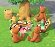 two brown teddy bears sitting at a picnic table with food and drinks on the grass