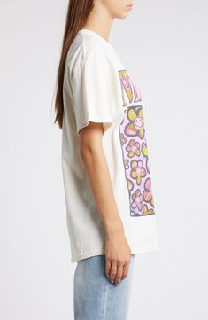 Strike up a conversation with a fellow fan in this oversized cotton T-shirt featuring the band's instantly recognizable smiley face in a field groovy blooms. 27" length (size Medium) Crewneck Short sleeves 100% cotton Machine wash, tumble dry Imported 90s Style Printed T-shirt For Spring, Oversized Retro T-shirt For Spring, Casual Cotton T-shirt For Concert, Oversized Band Merch T-shirt For Spring, Soft-washed Tops For Spring Concert, Oversized Screen Print T-shirt For Spring, Groovy Short Sleeve T-shirt With Funny Print, Oversized Retro Cotton T-shirt, Summer Concert Cotton T-shirt