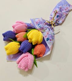 a bouquet of knitted tulips tied to a purple ribbon