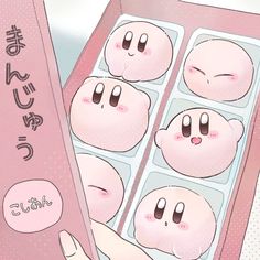 an open box of donuts with faces drawn on the inside and in japanese writing