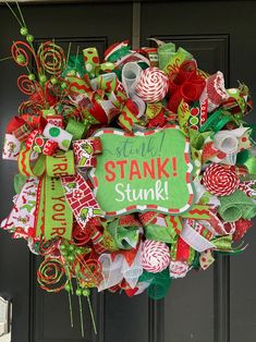 a christmas wreath with the words stink stank and candy canes attached to it