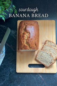 a loaf of banana bread sitting on top of a cutting board