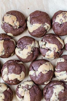 chocolate chip cookies with white icing on top are lined up in a row and ready to be eaten