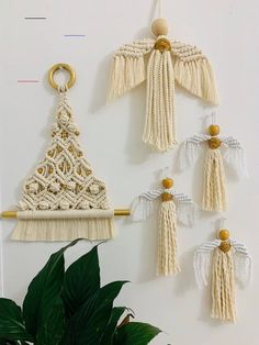 macrame wall hangings with tassels and gold accents on a white wall