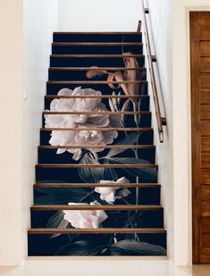 an artistic stair case with flowers painted on it