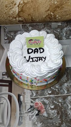 a birthday cake with the words dad yummy written on it sitting on a table