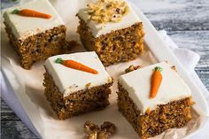 carrot cake with white frosting on a plate