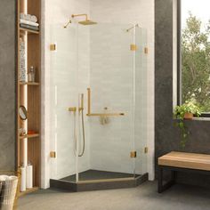 a bathroom with a walk in shower next to a wooden bench and window on the wall