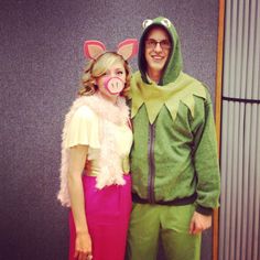 a man and woman dressed up in costumes posing for a photo with pig ears on