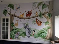 the wall mural is painted with animals and trees