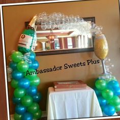 balloon arch with wine bottle and glasses on it for an ambassador sweets plus party