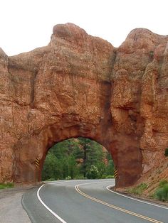 a large rock formation on the side of a road