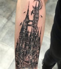 a black and white tattoo of a castle