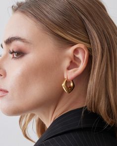 Smaller size huggie hoop earrings that fits snuggly around the ear. This luxury hoop is made 18K gold plated over sterling silver. Modern and sleek design with every single piece hand polished to perfection. Each pair of earrings are produce using our exclusive Italian electroforming technology to control the weight to maximize comfort. This design is available in 2 colors, 18k yellow gold or white gold. Closure: Hoop Stamp Closure Approx. Measurement: Outer Length: 1.1 inches Outer Width: 1 inc Luxury Yellow Gold Modern Huggie Earrings, Modern Shiny Huggie Earrings, Modern Gold Plated Huggie Earrings, Minimalist Gold Plated Hoop Earrings With Shiny Finish, Minimalist Gold Plated Hoop Earrings With Polished Finish, Modern Shiny Huggie Earrings As Gift, Modern Huggie Earrings With Shiny Finish As Gift, Modern Pierced Huggie Earrings, Gold Plated Huggie Earrings With Polished Finish