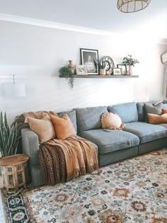 a living room filled with lots of furniture and decor on top of a carpeted floor