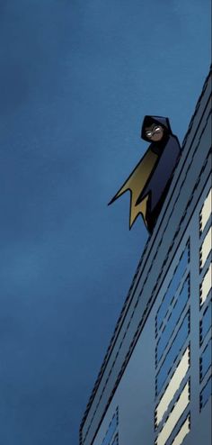 a batman flying over the top of a tall building in front of a blue sky