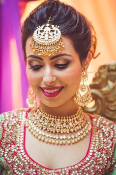 a woman wearing a necklace and earrings