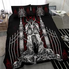 a bed covered in black and red sheets with an image of a demon on it